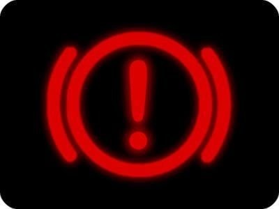 The brake warning light illuminated on a Mini Cooper dashboard