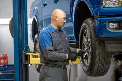 Technician performing engine diagnostics
