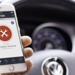 Fixd sensor plugged into a car's OBD-II port for vehicle diagnostics