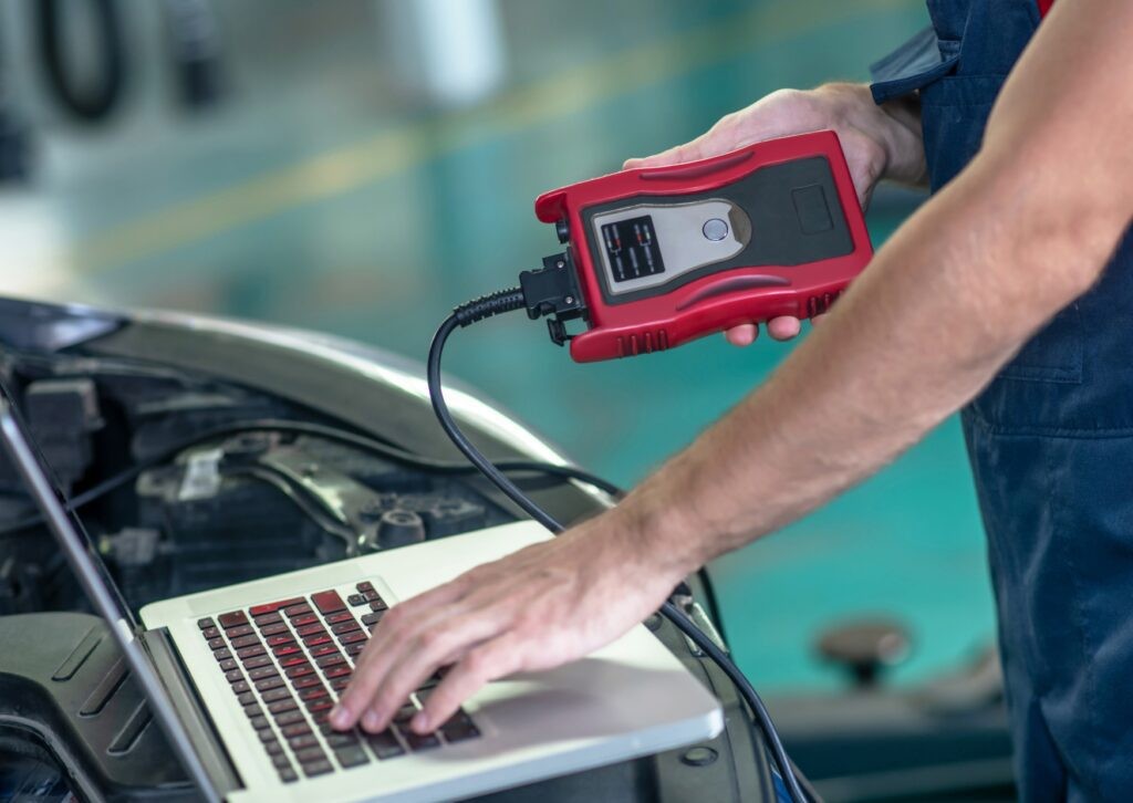 mechanic performing car diagnostic test