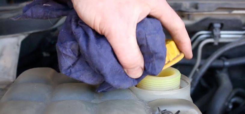 Technician inspecting a car radiator