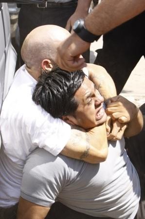 GULP! An alleged thief gets an AutoZone employee in a headlock yesterday before the tables were turned.