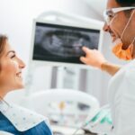 A dentist showing a patient their x-ray results