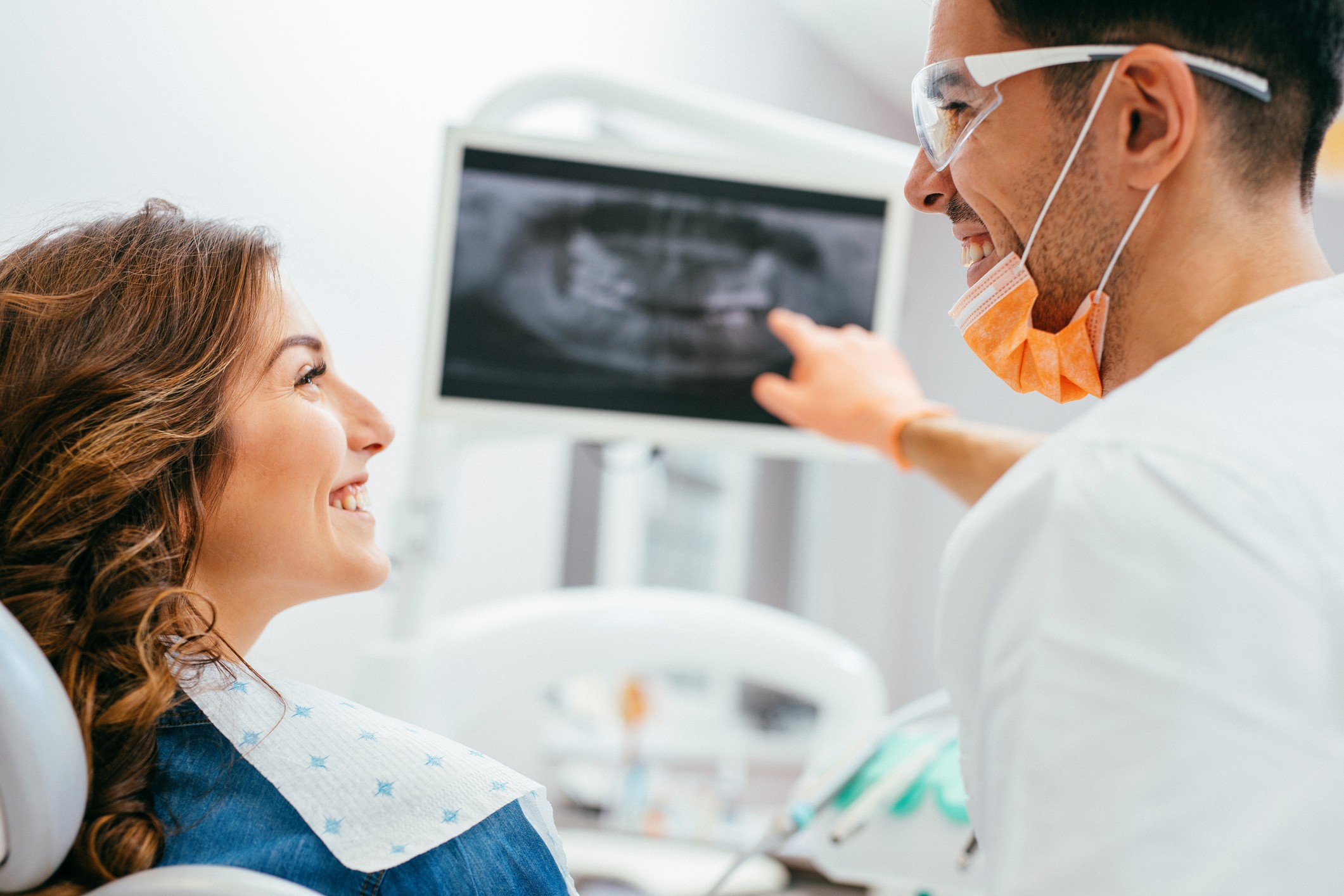 A dentist showing a patient their x-ray results