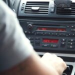 Mechanic using diagnostic tool on car engine
