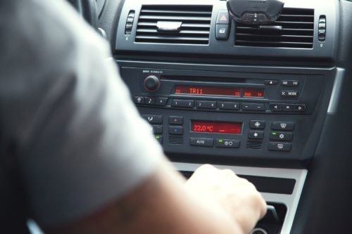 Mechanic using diagnostic tool on car engine
