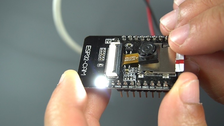 Technician utilizing a camcammer for detailed automotive inspection