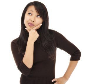 Woman in a medical setting thoughtfully considering sonography as a career choice.