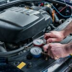 Man recharging car's AC with Freon