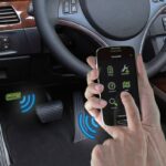 OBDLink LX Bluetooth adapter connected to a car's OBD-II port