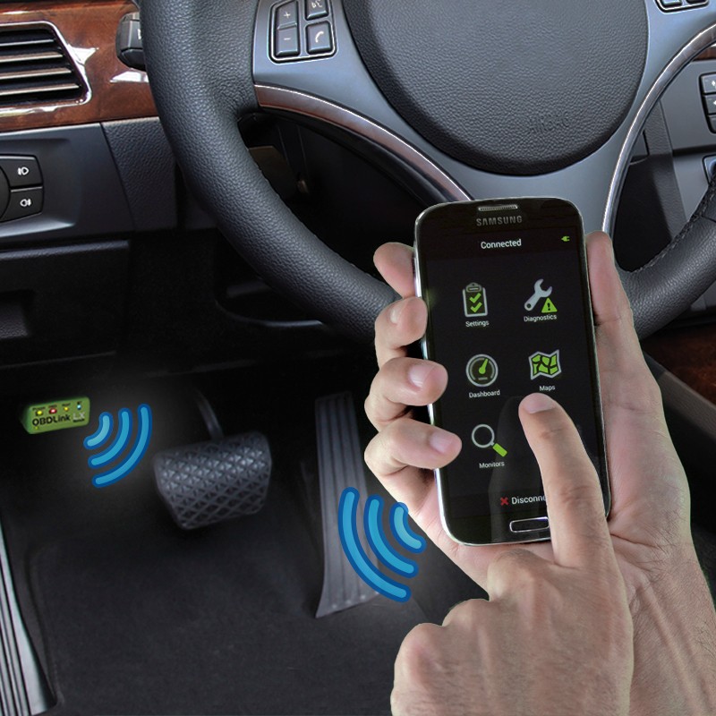 OBDLink LX Bluetooth adapter connected to a car's OBD-II port