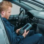 Mechanic Using Auto Diagnostics Tool
