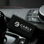 Carly connector positioned next to gear lever in a car
