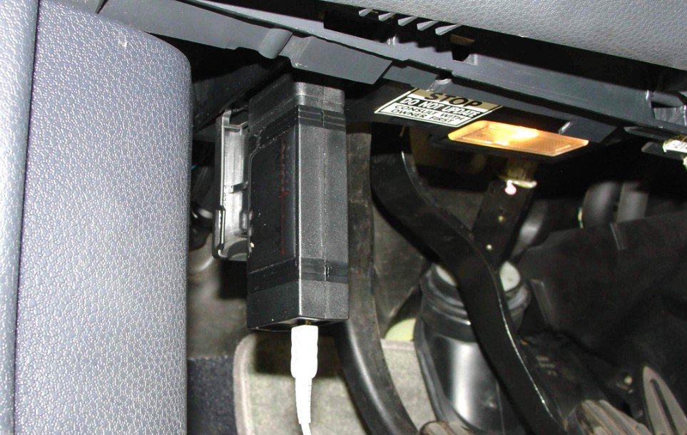 An OBD-II scanner plugged into a Mini Cooper's diagnostic port