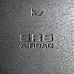 Toyota steering wheel with an SRS marking indicating the presence of an airbag