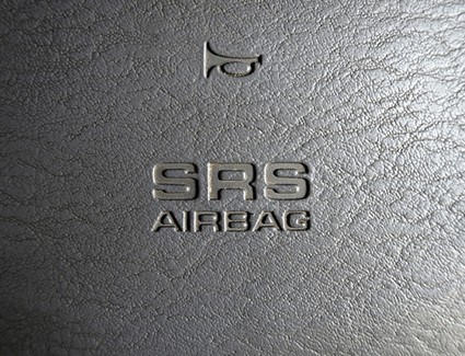 Toyota steering wheel with an SRS marking indicating the presence of an airbag