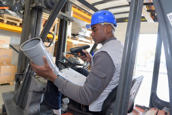 Forklift operator using an RF scanner to scan an item in a loading dock